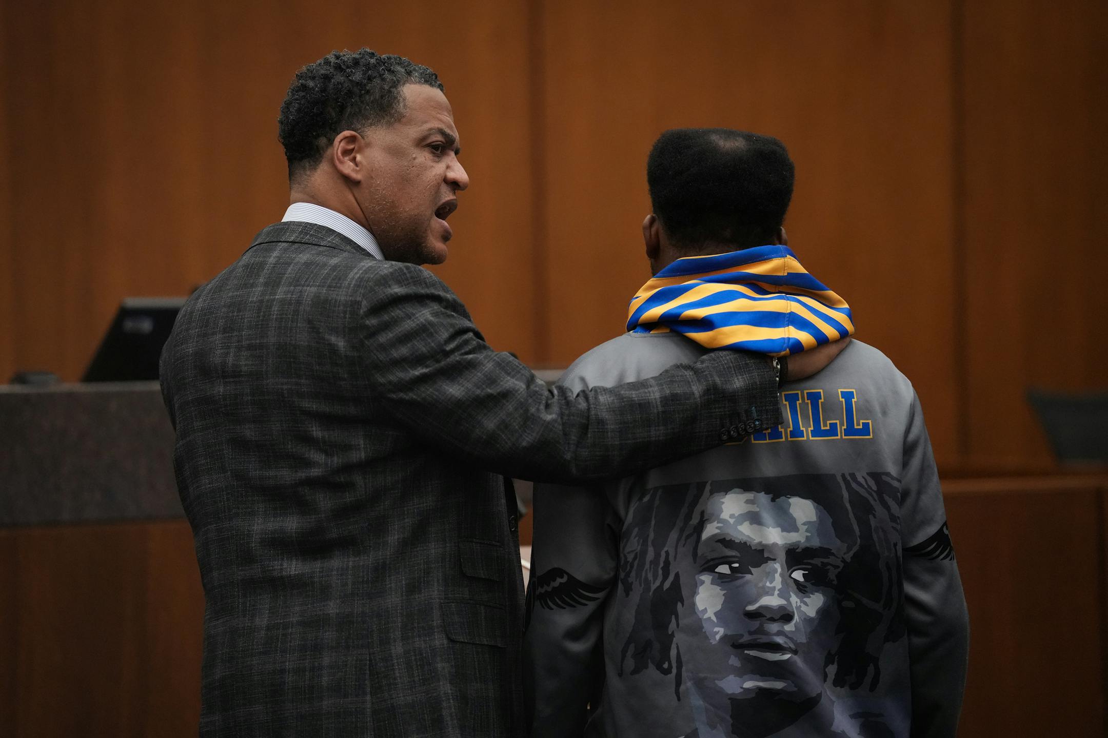 Attorney William Walker puts his arm around Deshaun Hill, Sr. while turning to look at Cody Fohrenkam as he gave a victim impact statement during the sentencing.