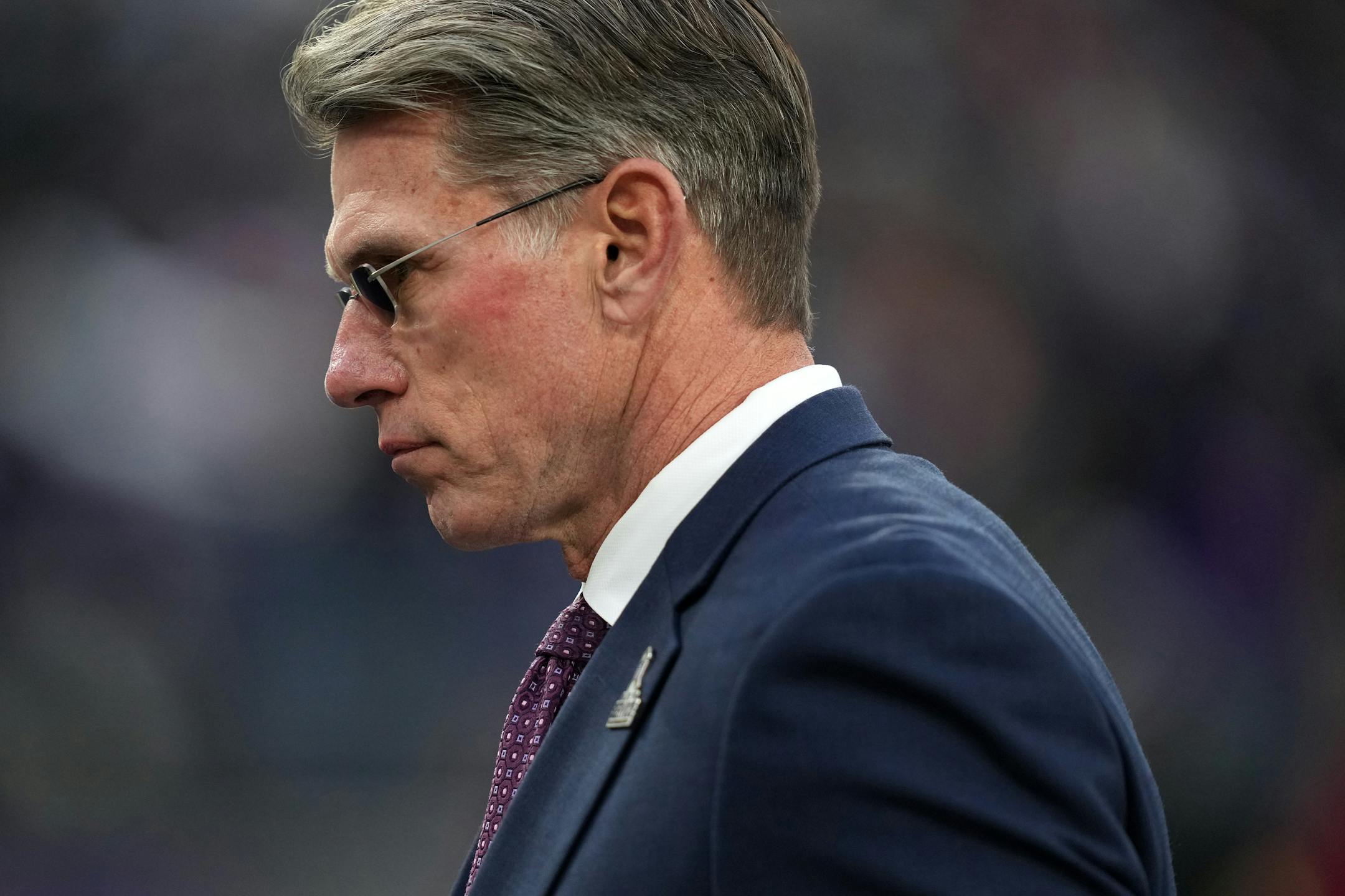 Vikings general manager Rick Spielman walks off the field after his team lost an NFL game in overtime to the Baltimore Ravens.