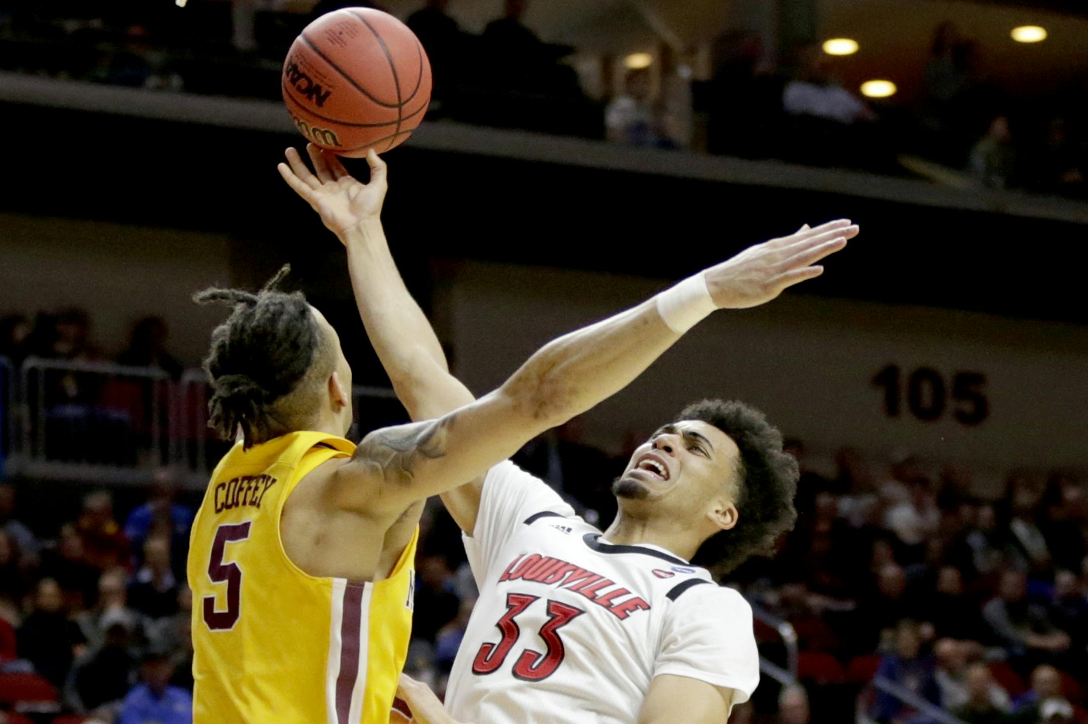Louisville's Jordan Nwora (33) goes to the basket against Minnesota's Amir Coffey (5) during the first half of a first round men's college basketball game in the NCAA Tournament, in Des Moines, Iowa, Thursday, March 21, 2019.