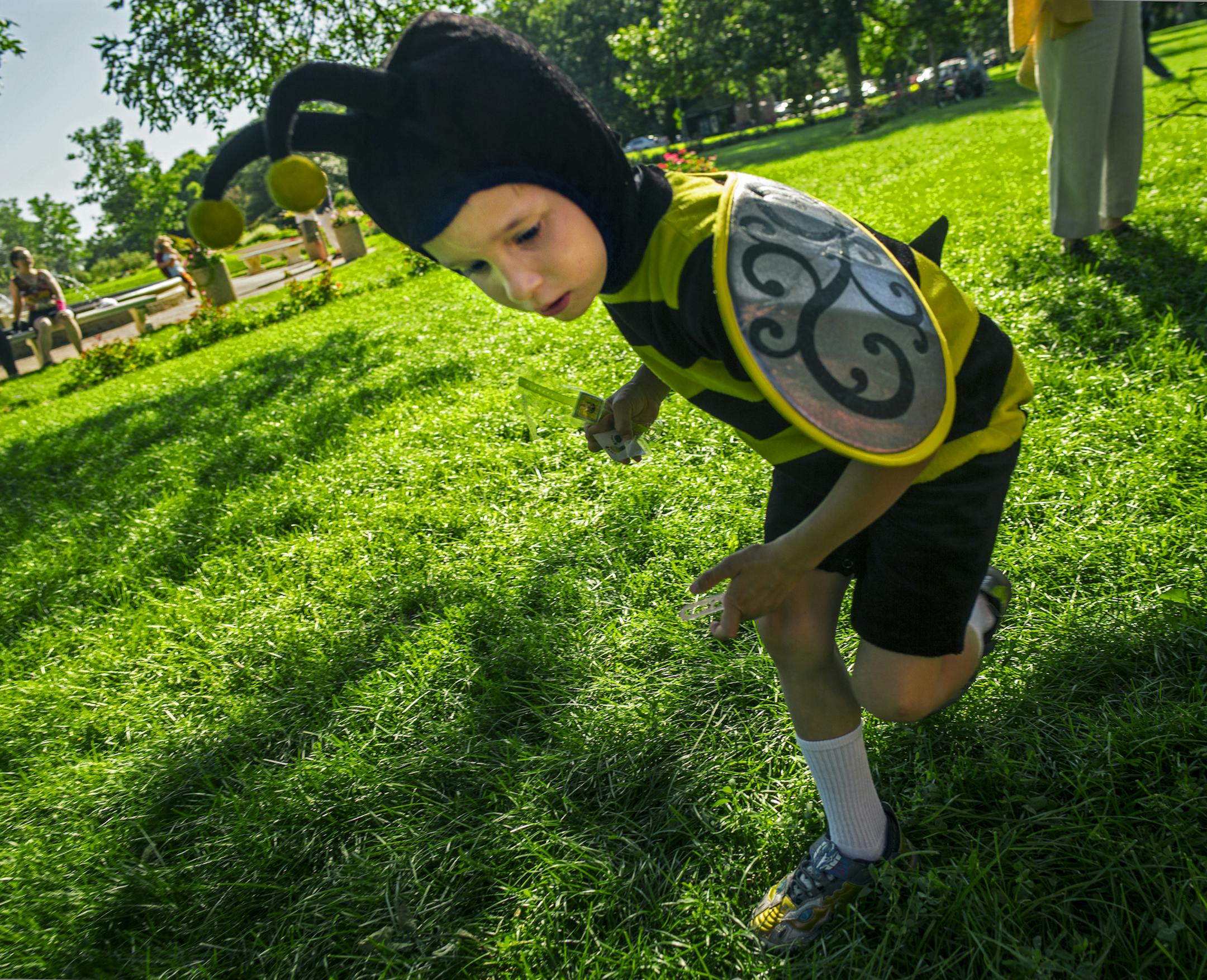 Bergen Dankey,5, buzzed about after picking up some candy from a bee hive pinada. His parents are part-time honey producers with 150 hives in the metro area. He likes to help with "smoking" the bees and pulling honey frames. "Pollinator Party: a Celebration of Bees" was held across from the Peace Garden in Minneapolis, .] Richard Tsong-Taatarii/rtsong-taatarii@startribune.com