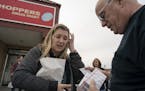Quinn Nystrom, a Minnesotan who traveled to Canada to buy lower-cost insulin, showed her dad Bob Nystrom insulin outside Shoppers Drug Market pharmacy