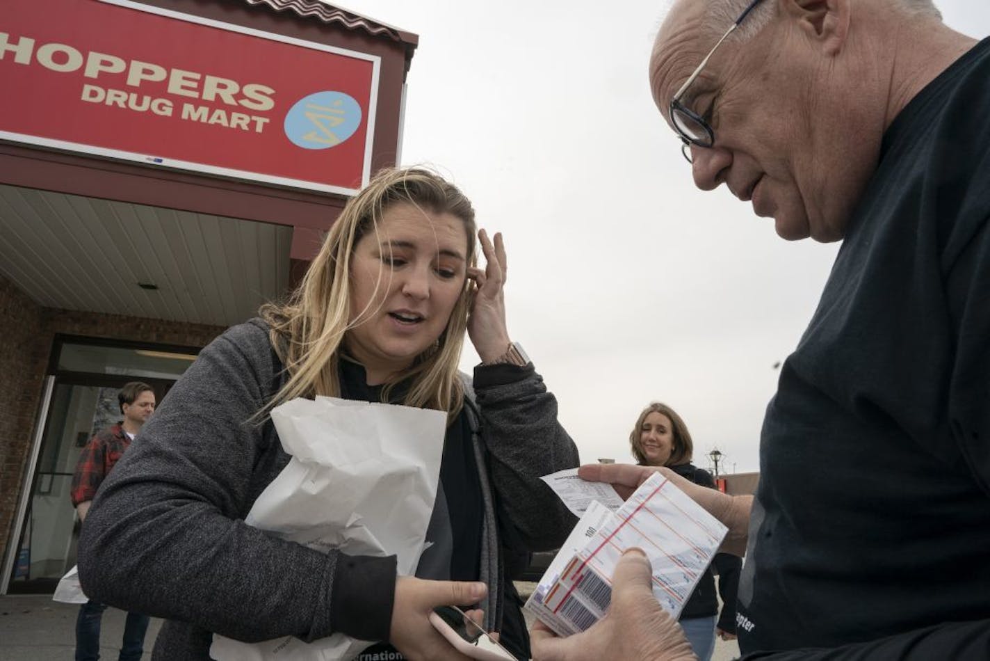 Quinn Nystrom, a Minnesotan who traveled to Canada to buy lower-cost insulin, showed her dad Bob Nystrom insulin outside Shoppers Drug Market pharmacy Saturday May 4, 2019 in Ft. Frances, Ontario.