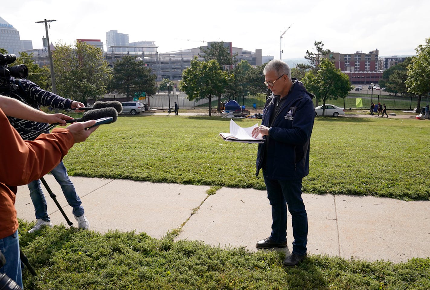 Ricardo Cervantes, director of St. Paul's Department of Safety and Inspections, read a statement to media members as a homeless encampment near downtown and I-35E was cleared Thursday in St. Paul. ]