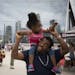 Anafiel Williams held his two-year-old daughter Ahavatiyah Williams as they roamed about at the first U.S. Bank Stadium Jack's Music on the Plaza in M