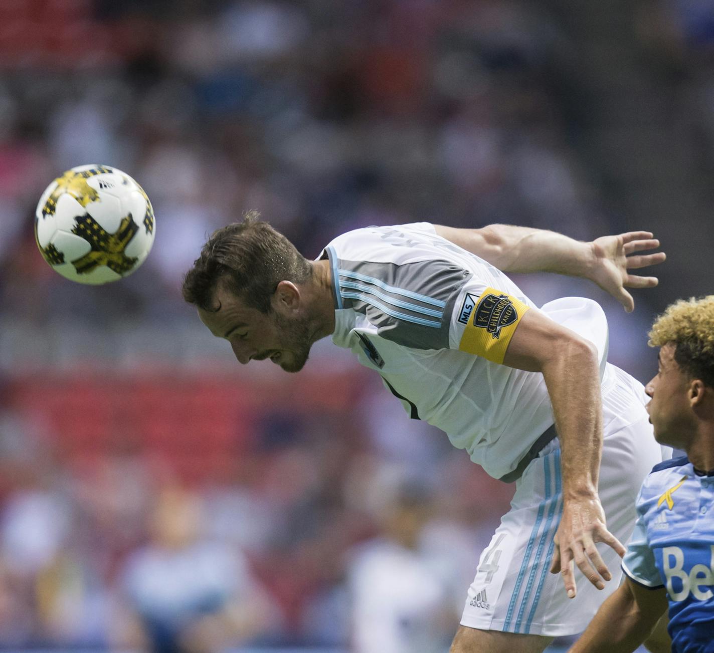 Minnesota United's Brent Kallman, left, gets his head on the ball to stop a pass intended for Vancouver Whitecaps' Erik Hurtado during the first half of an MLS soccer match Wednesday, Sept. 13, 2017, in Vancouver, British Columbia. (Darryl Dyck/The Canadian Press via AP) ORG XMIT: VCRD107