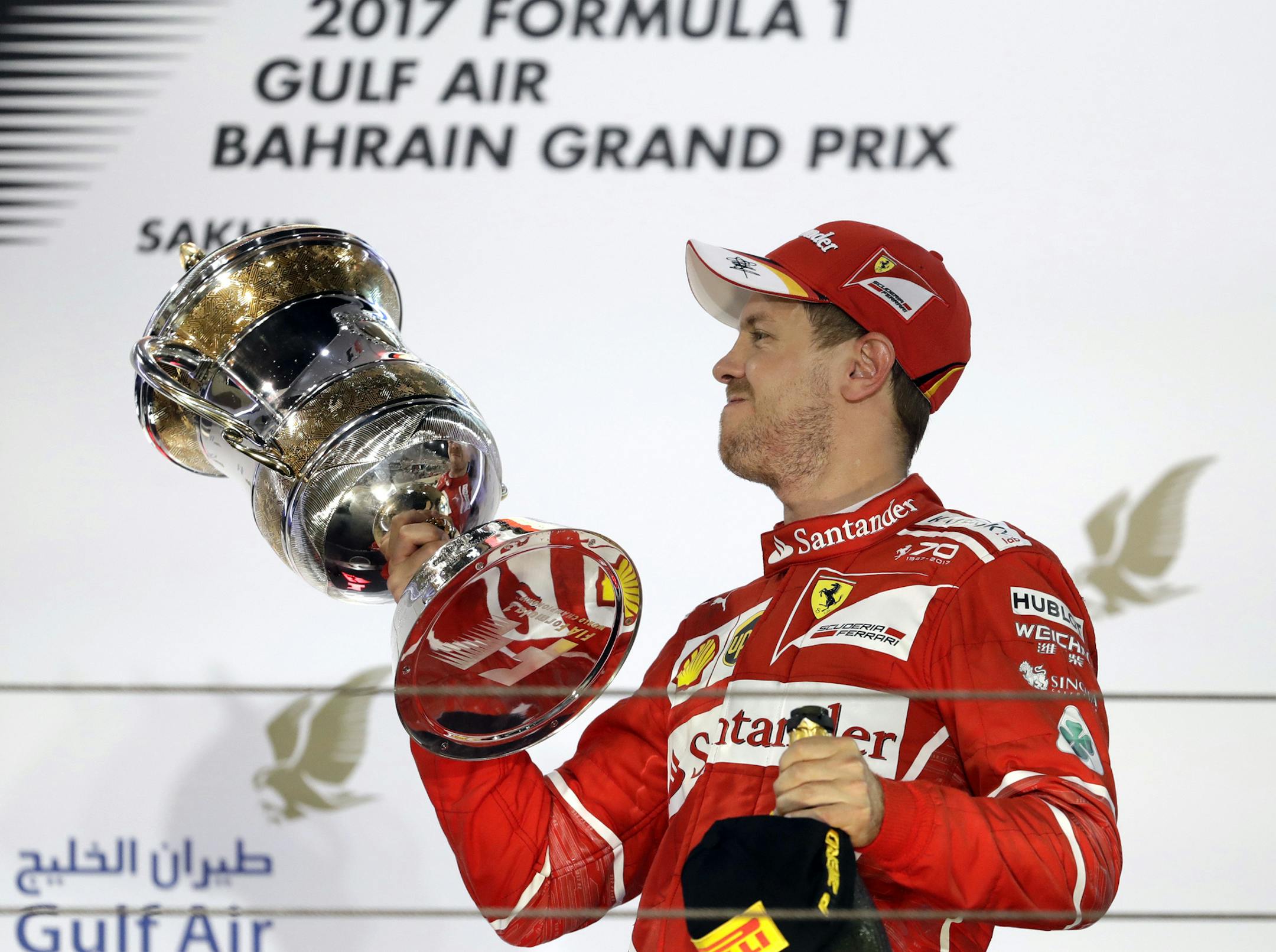 Ferrari driver Sebastian Vettel of Germany, right, celebrates after winning the Bahrain Formula One Grand Prix at the Formula One Bahrain International Circuit in Sakhir, Bahrain, Sunday, April 16, 2017. (AP Photo/Luca Bruno)