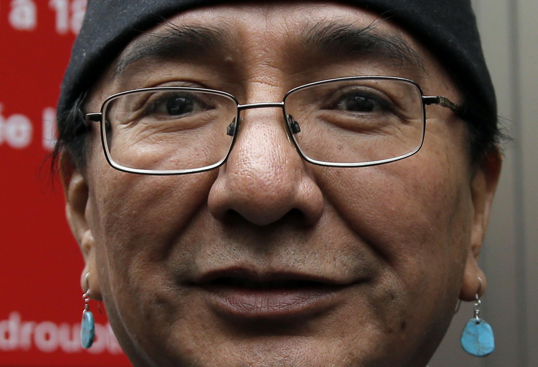 Native American Navajo Nation Vice president Rex Lee Jim poses for the media outside of the Drouot's auction house prior to the contested auction of Native American Navajo tribe masks in Paris, Monday Dec. 15, 2014. Navajo officials have spent several hundred thousand euros to buy back seven tribal masks put up for sale at a disputed auction despite the U.S. Embassy in Paris asked Drouot to suspend the sale to allow Navajo and Hopi representatives to determine where they came from. (AP Photo/Fra
