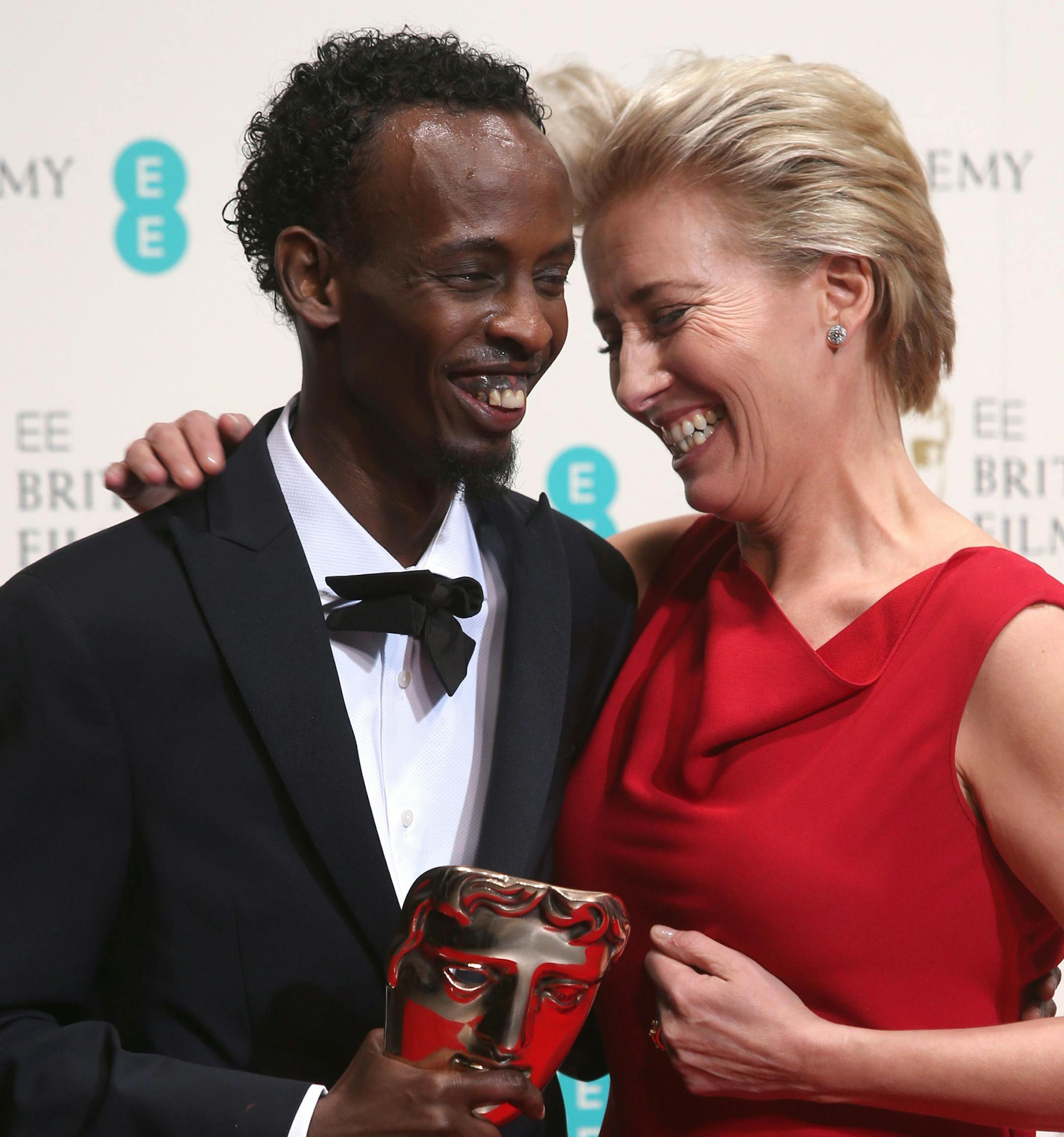 Barkhad Abdi, winner of best supporting actor and Emma Thompson pose for photographers in the winners room at the EE British Academy Film Awards held at the Royal Opera House on Sunday Feb. 16, 2014, in London. (Photo by Joel Ryan/Invision/AP)