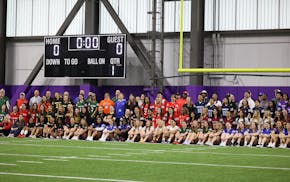 Flag football players pose for a photo ahead of the Vikings' expanded spring season at the TCO training facilities in Eagan on Saturday, March 30, 202