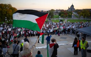 Hundreds of people chanted slogans together and listened to speakers during the rally at the State Capitol. The Anti-War Committee and other groups or