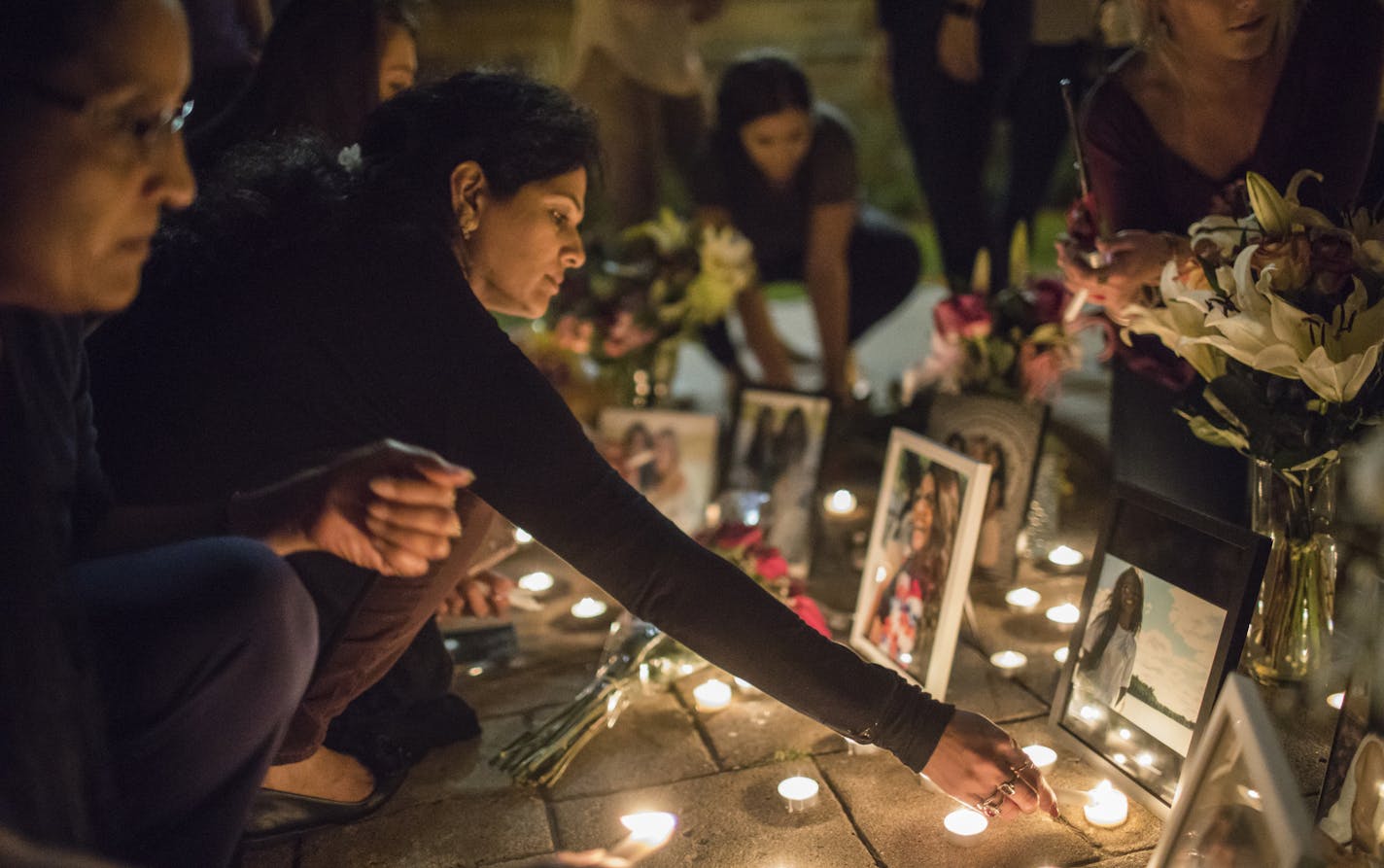 Ria Patel's mother Devyani Patel continually lit candles around her pictures during a vigil for Ria at St. Thomas University on Thursday, September 21, 2017, in St. Paul, Minn. ] RENEE JONES SCHNEIDER &#x2022; renee.jones@startribune.com