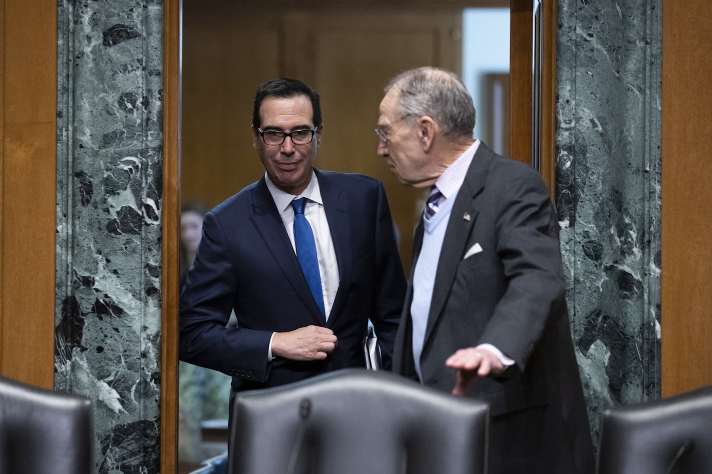 Treasury Secretary Steve Mnuchin, left, and Senate Finance Committee Chairman Chuck Grassley, of Iowa, in a February photo at the U.S. Capitol. They disagree over the taxes that businesses should face for taking government aid in the pandemic.