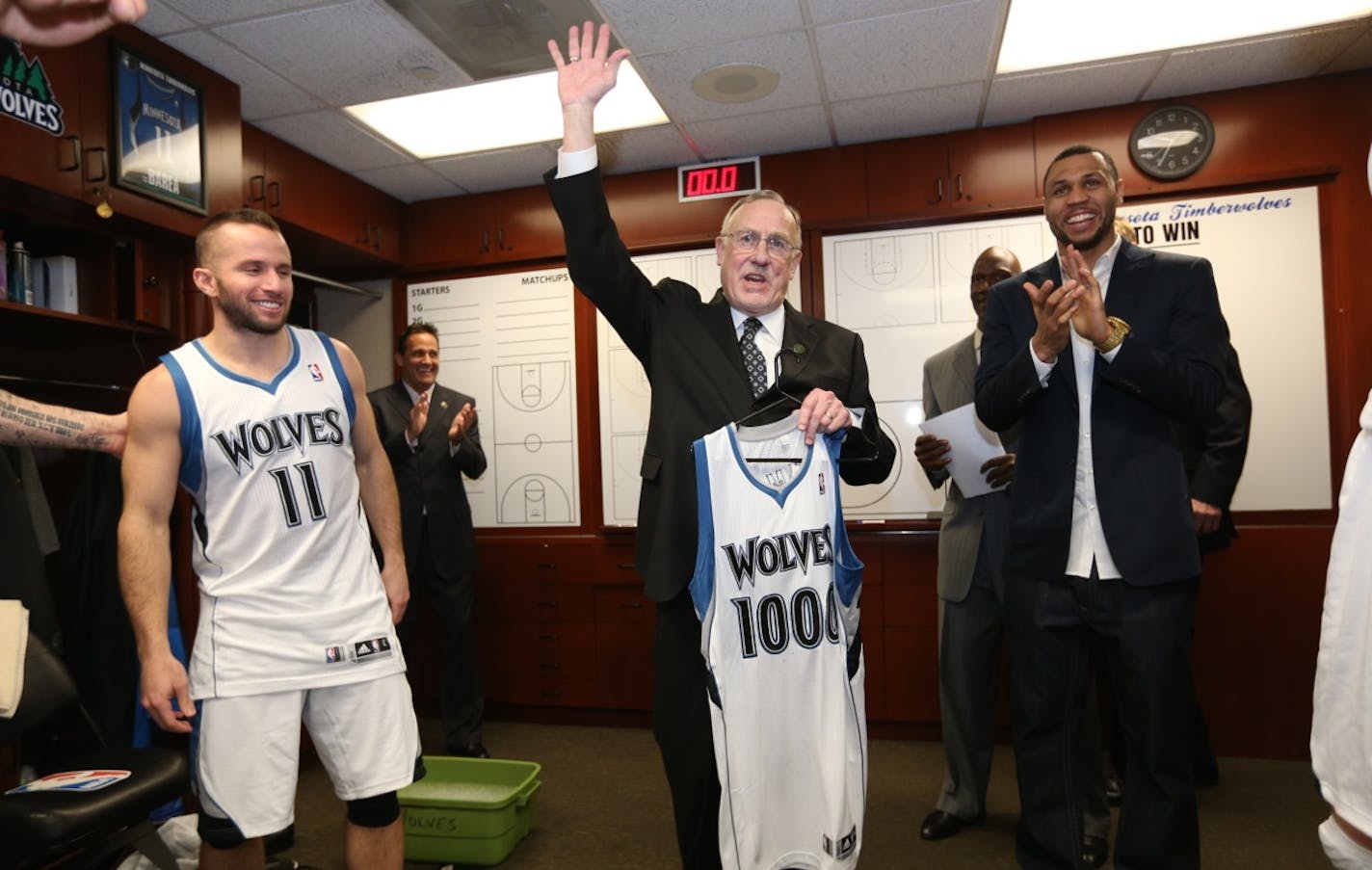 Wolves coach Rick Adelman accepted a special jersey in the locker room after claiming his 1,000th victory Saturday when his team beat Detroit. Guard J.J. Barea is at left.