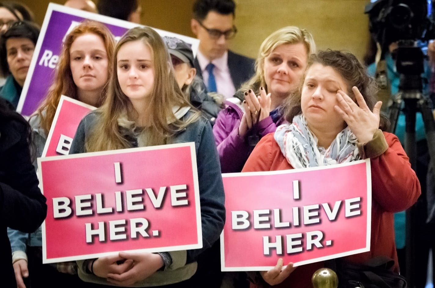 Cynthia Miller, right, wiped away tears as many speakers talked about how they were sexually harassed in the past. She came to the protest with friend Cherste Eidman, center, and Eidman's two daughters Sophie 15, and Martha, 17.