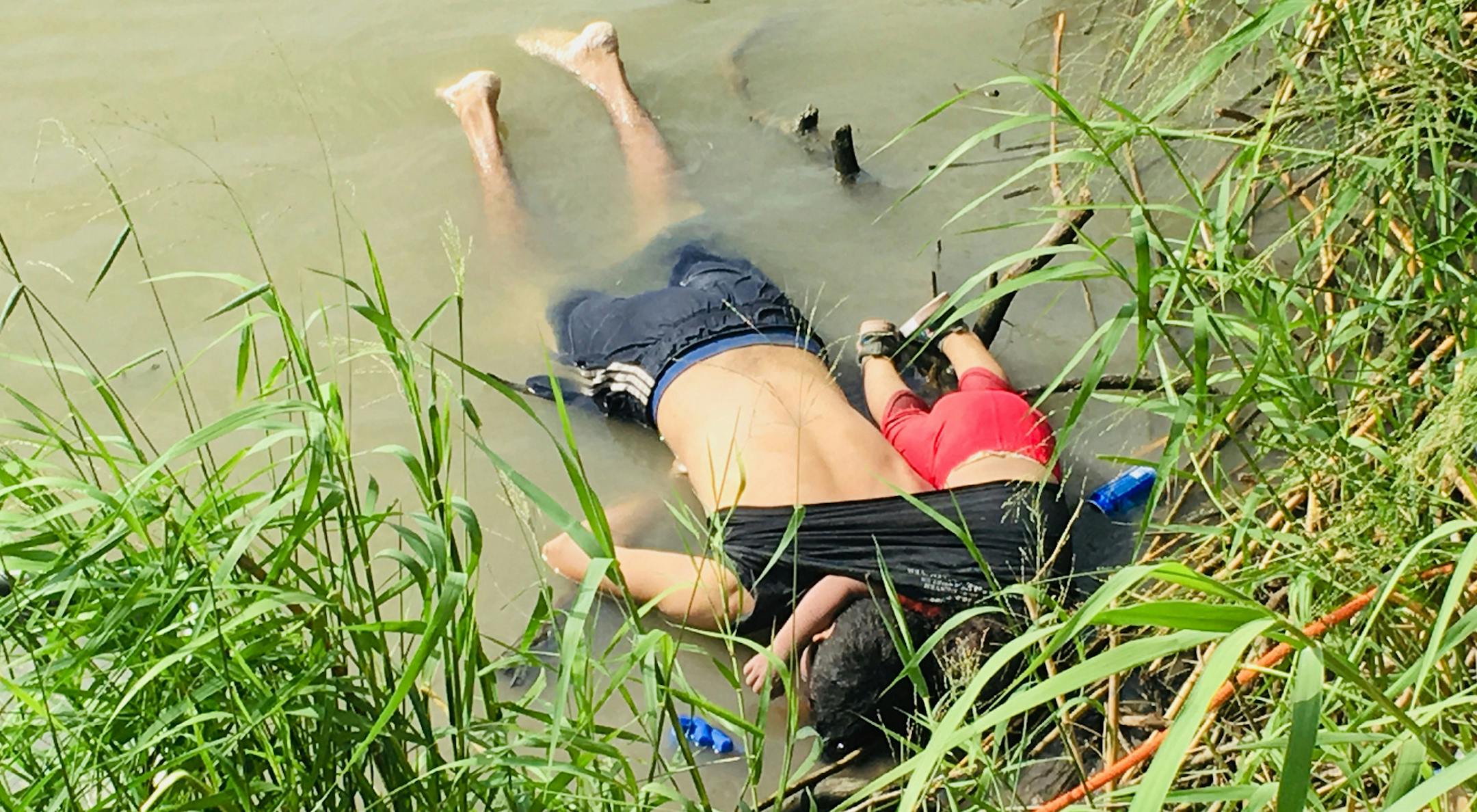 ADDS THAT PHOTO WAS FIRST PUBLISHED IN MEXICAN NEWSPAPER LA JORNADA - EDS NOTE: GRAPHIC CONTENT - The bodies of Salvadoran migrant Oscar Alberto Martínez Ramírez and his nearly 2-year-old daughter Valeria lie on the bank of the Rio Grande in Matamoros, Mexico, Monday, June 24, 2019, after they drowned trying to cross the river to Brownsville, Texas. Martinez' wife, Tania told Mexican authorities she watched her husband and child disappear in the strong current. This photograph was firs