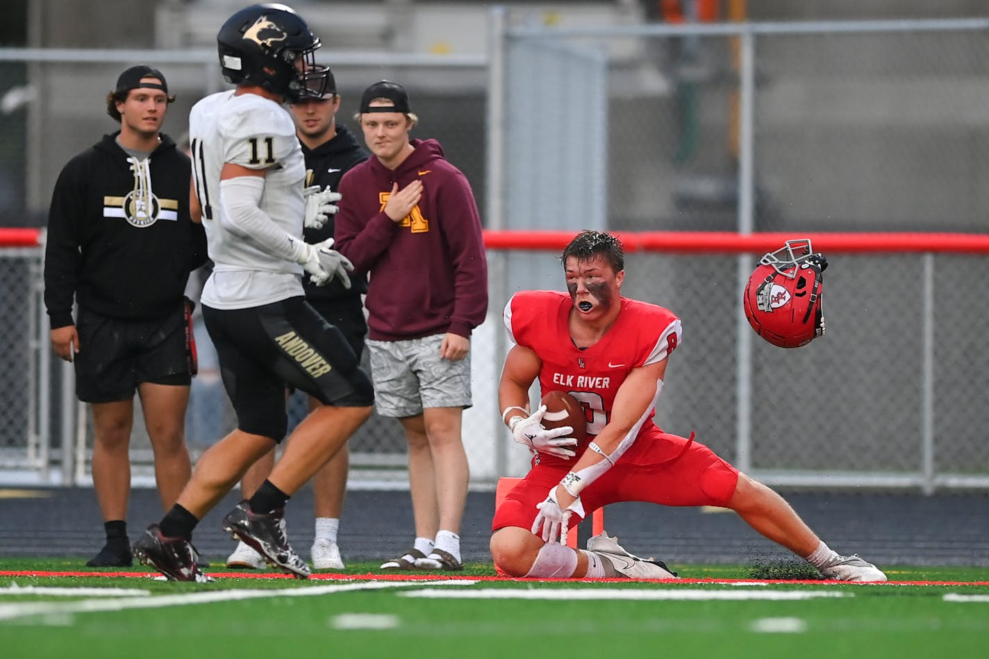 Elk River tight end Caleb Sandstrom (8) loses his helmet as he rolls on the ground during the first quarter against Andover Friday, Sept. 9, 2022 during the first half of a football game at Elk River High School in Elk River, Minn. ] aaron.lavinsky@startribune.com