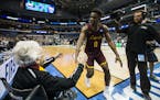 Sister Jean Dolores-Schmidt, a 98-year-old nun and Loyola Ramblers superfan, celebrates with Loyola's Donte Ingram (0) and the team on the court after