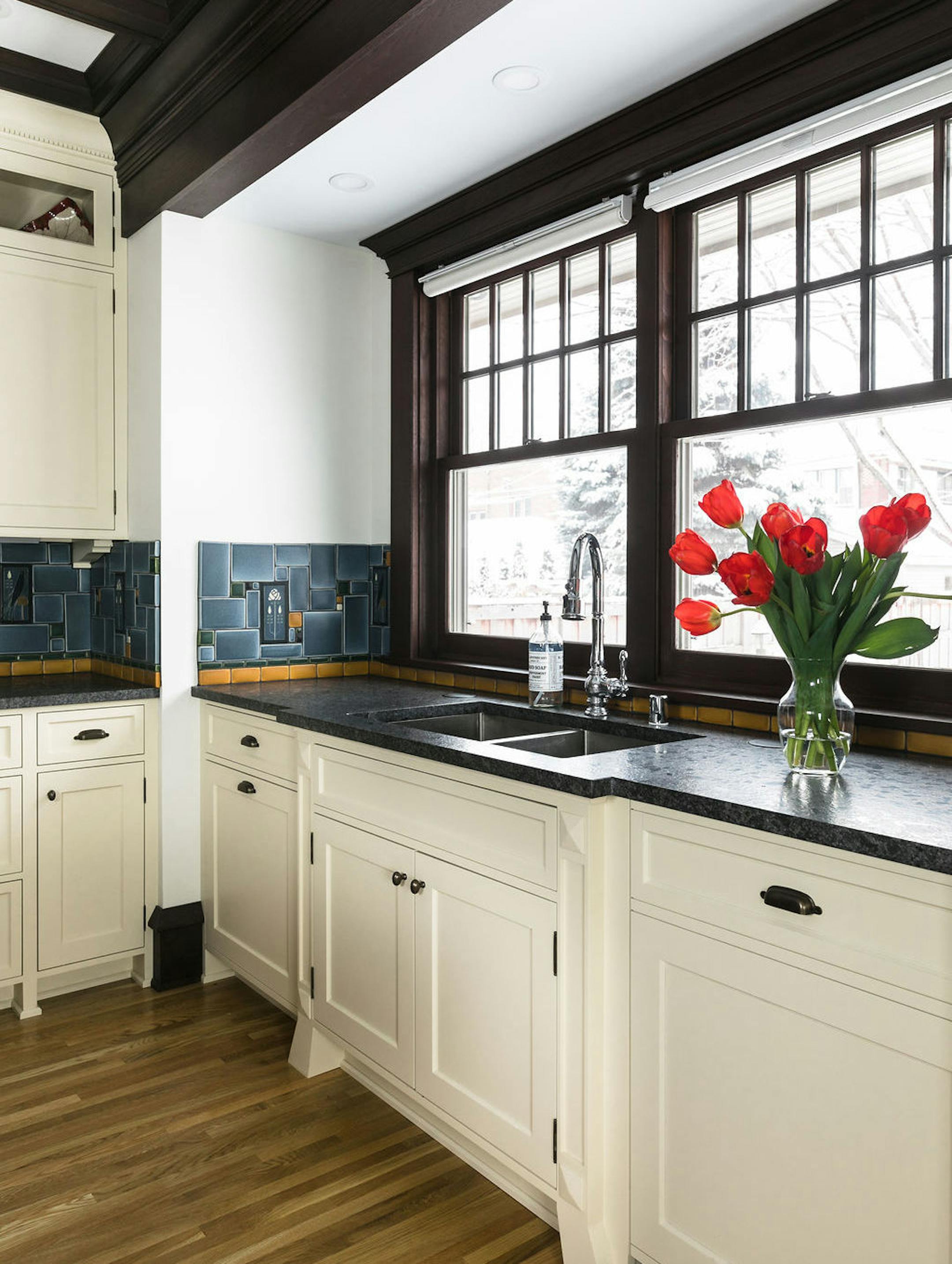The window above the sink overlooks the backyard.