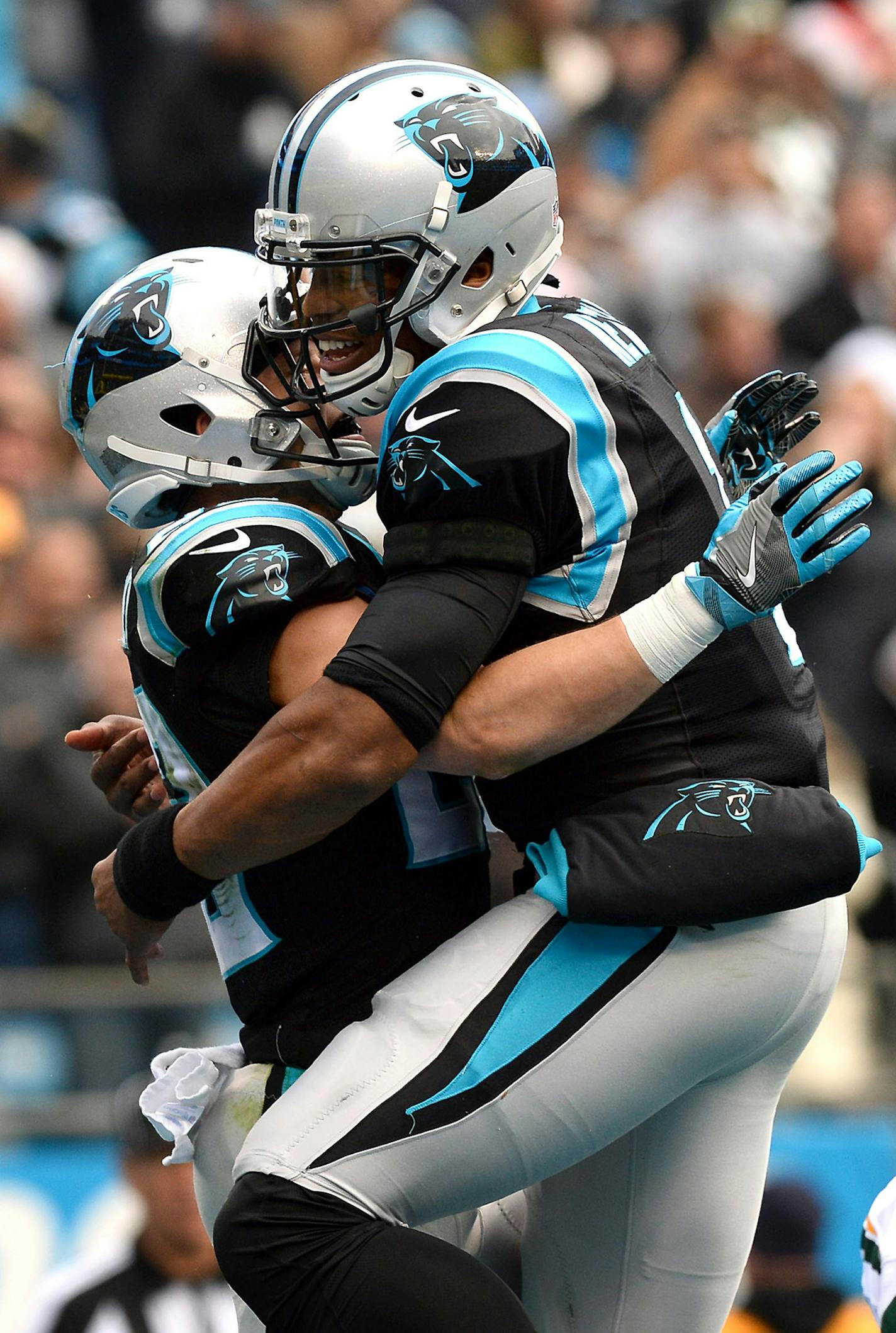 Carolina Panthers quarterback Cam Newton, right, leaps onto running back Christian McCaffrey, right, as they celebrate McCaffrey's touchdown against the Green Bay Packers during first quarter action on Sunday, Dec. 17, 2017 at Bank of America Stadium in Charlotte, N.C. (Jeff Siner/Charlotte Observer/TNS)