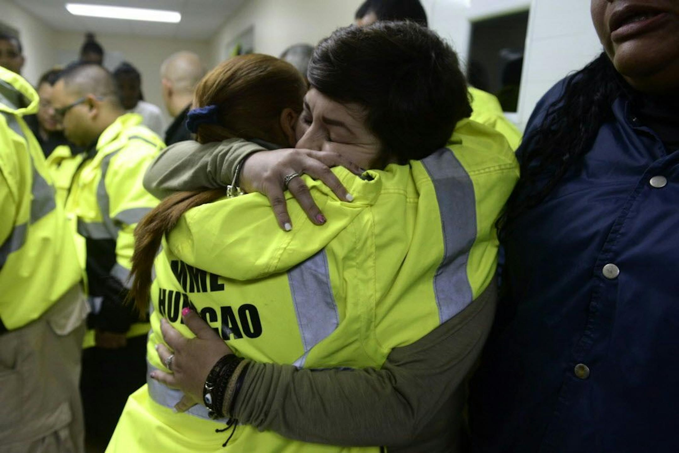 Rescue team members Candida Lozada, left, and Stephanie Rivera, right, hug as they share their frustration over being unable to go out to answer several calls for help from citizens in need of assistance as Hurricane Maria made landfall on Puerto Rico.