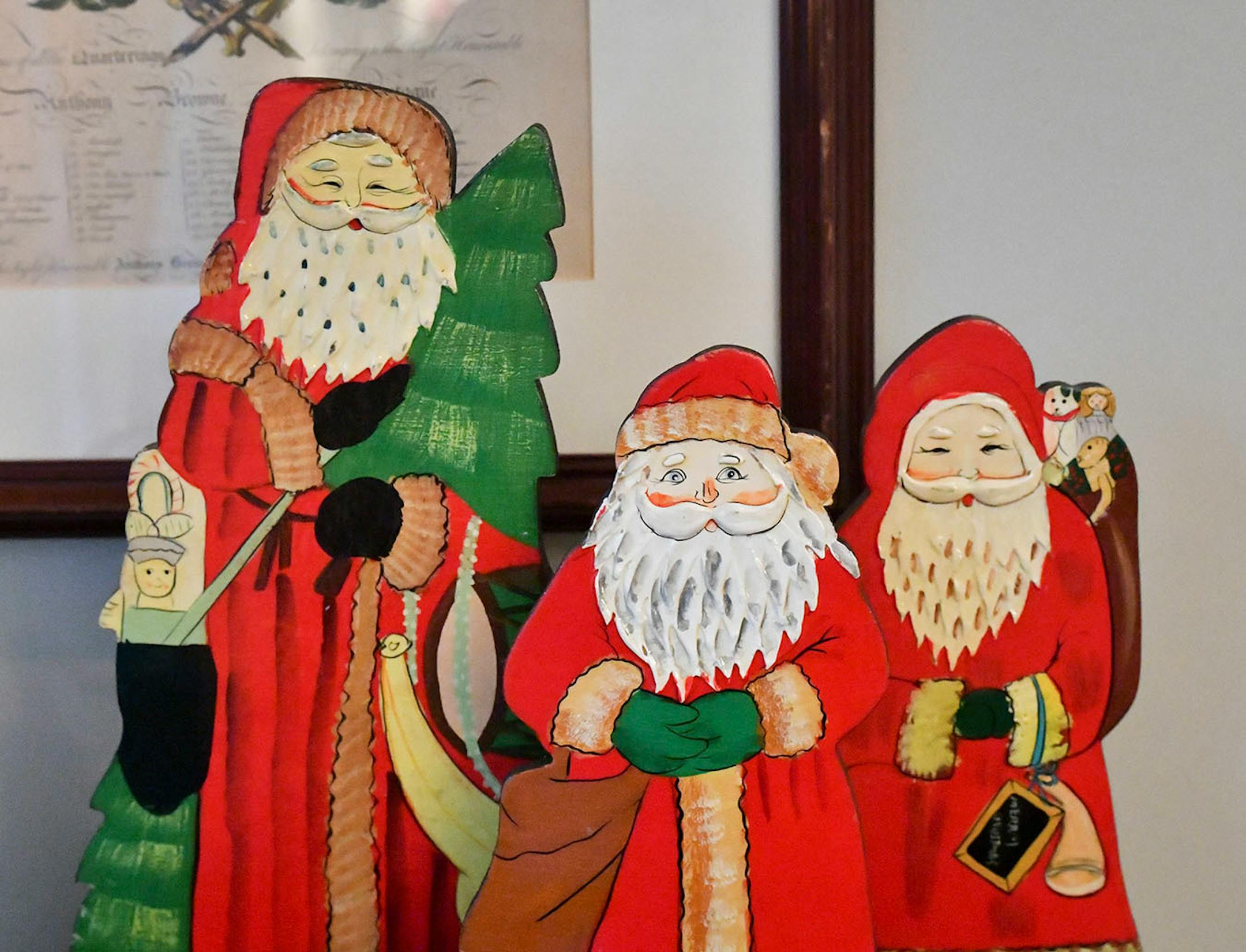 Three colorful painted vintage Santas from Germany are the centerpiece of the display.