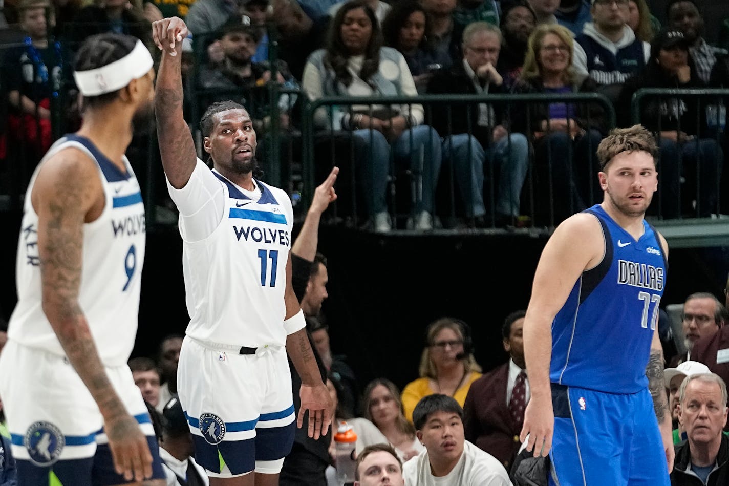 Timberwolves center Naz Reid reacted after hitting a three-point basket as Mavericks guard Luka Doncic looks on during the first half Thursday.