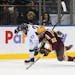 SPECIAL TO MINNEAPOLIS STAR TRIBUNE -- Michigan State Spartans forward Cody Milan (23) collides with Minnesota Golden Gophers forward Tyler Sheehy (22