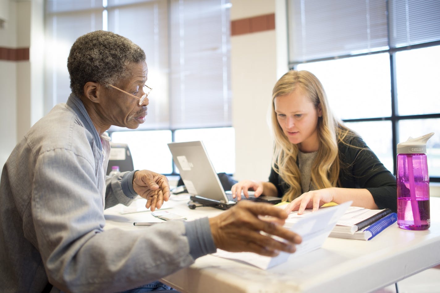 Jeffrey Johnson, of St. Paul, went through tax documents with Prepare and Prosper tax preparer Michelle Schjodt during a tax clinic in 2015. This year Minnesota is extending the deadline to July 15 to file state income taxes.