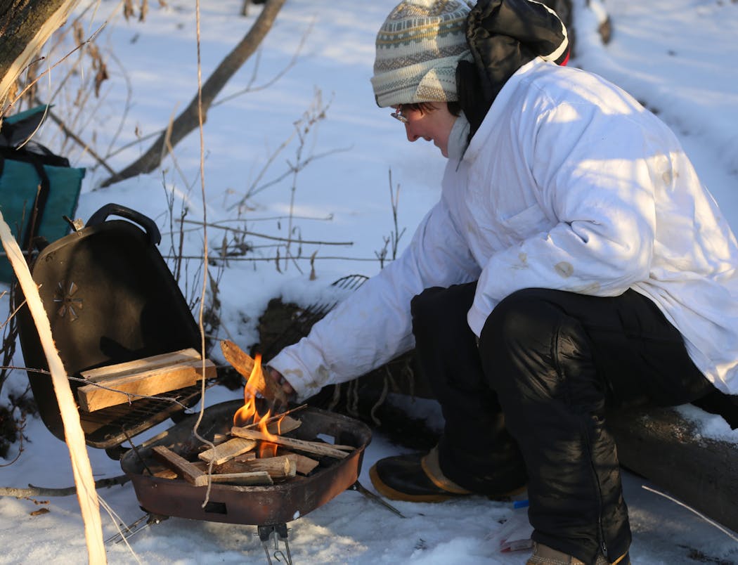 Galina Diller tinkered with the early makings of a wood fire, set on delivering a good breakfast for the hunting party. Her specialty: Siberian pancakes, from batter concocted at home.