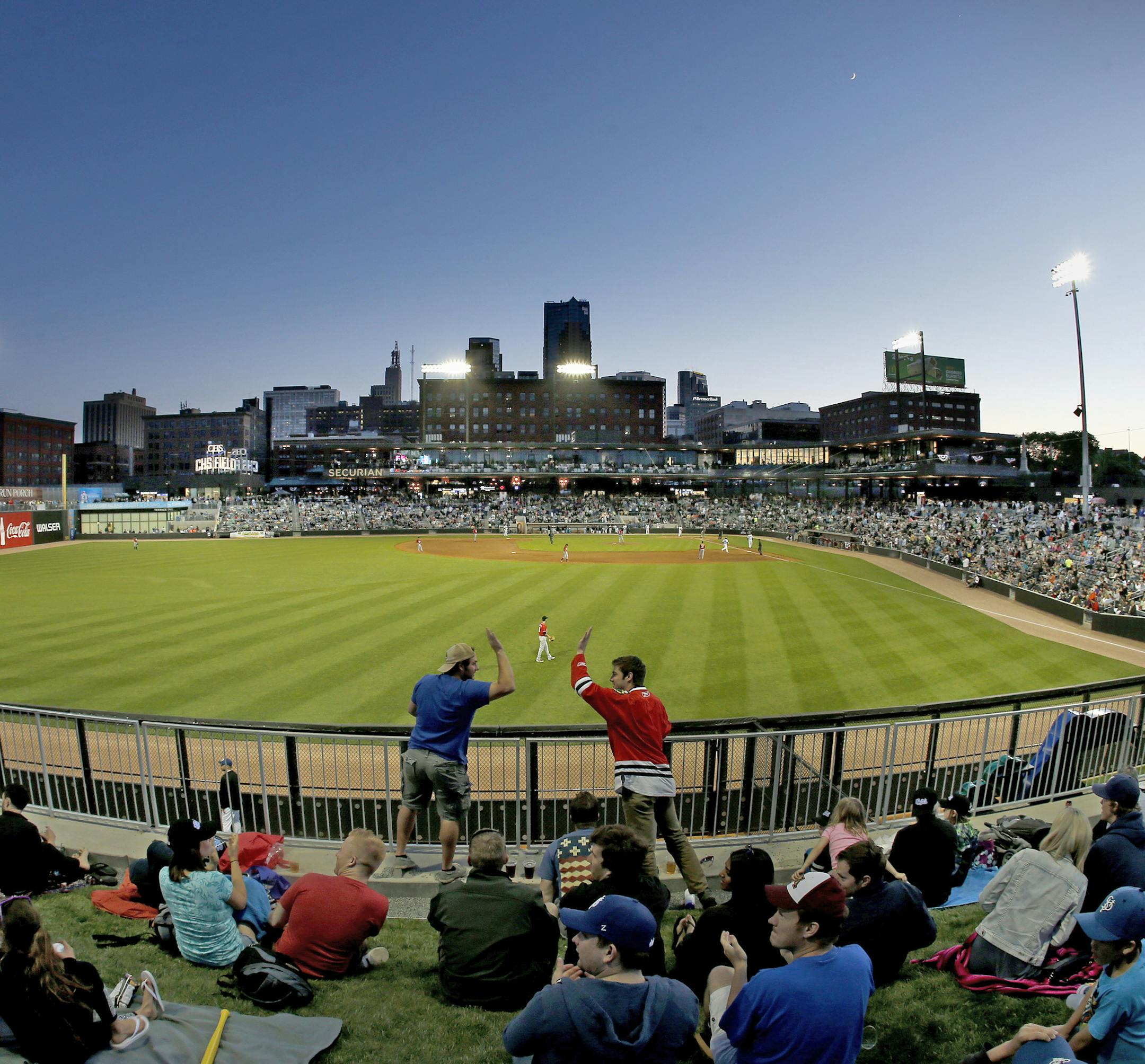 Fans celebrated a St. Paul Saints homerun in the fourth inning. ] CARLOS GONZALEZ cgonzalez@startribune.com, May 21, 2015, St Paul, MN, CHS Field, St. Paul Saints Baseball, First game at the new CHS Field ORG XMIT: MIN1505212103341818