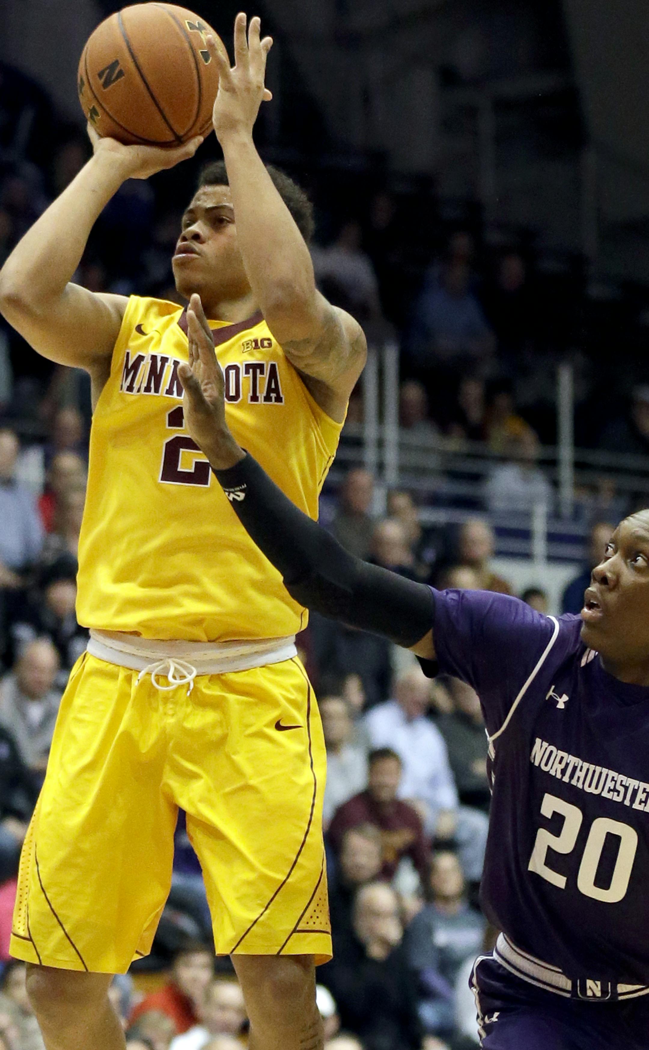 Minnesota guard Nate Mason, left, shoots against Northwestern guard/forward Scottie Lindsey during the first half of an NCAA college basketball game on Thursday, Feb. 4, 2016, in Evanston, Ill. (AP Photo/Nam Y. Huh)