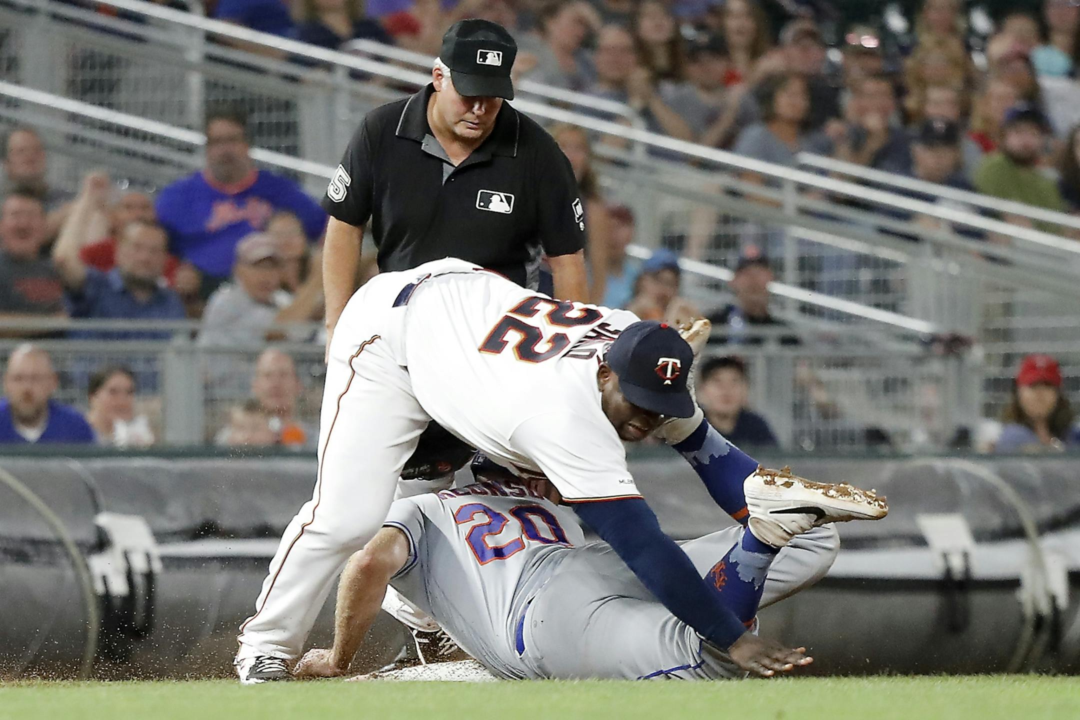 Minnesota Twins third baseman Miguel Sano (22) tags out New York Mets first baseman Pete Alonso (20) at third base for a double play in the eighth inning.