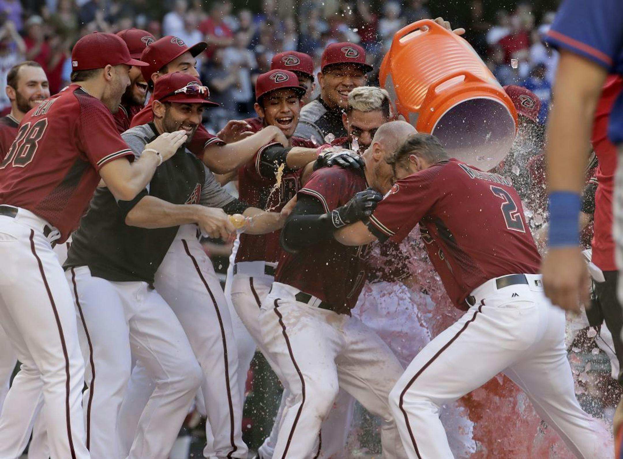 Arizona Diamondbacks Chris Herrmann, center, celebrates his walk-off home run during the 11th inning of a baseball game against the New York Mets, Wednesday, May 17, 2017, in Phoenix. The Diamondbacks won 5-4.