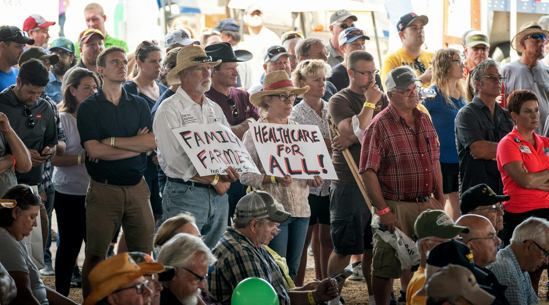 Some in the Farmfest crowd held signs. All five leading candidates for governor - Republicans Tim Pawlenty and Jeff Johnson, and DFLers Erin Murphy, Lori Swanson and Tim Walz - shared a stage for a forum at the FarmFest ag expo ] GLEN STUBBE ï glen.stubbe@startribune.com Wednesday, August 8, 2018 All five leading candidates for governor - Republicans Tim Pawlenty and Jeff Johnson, and DFLers Erin Murphy, Lori Swanson and Tim Walz - shared a stage for a forum at the FarmFest ag expo in south