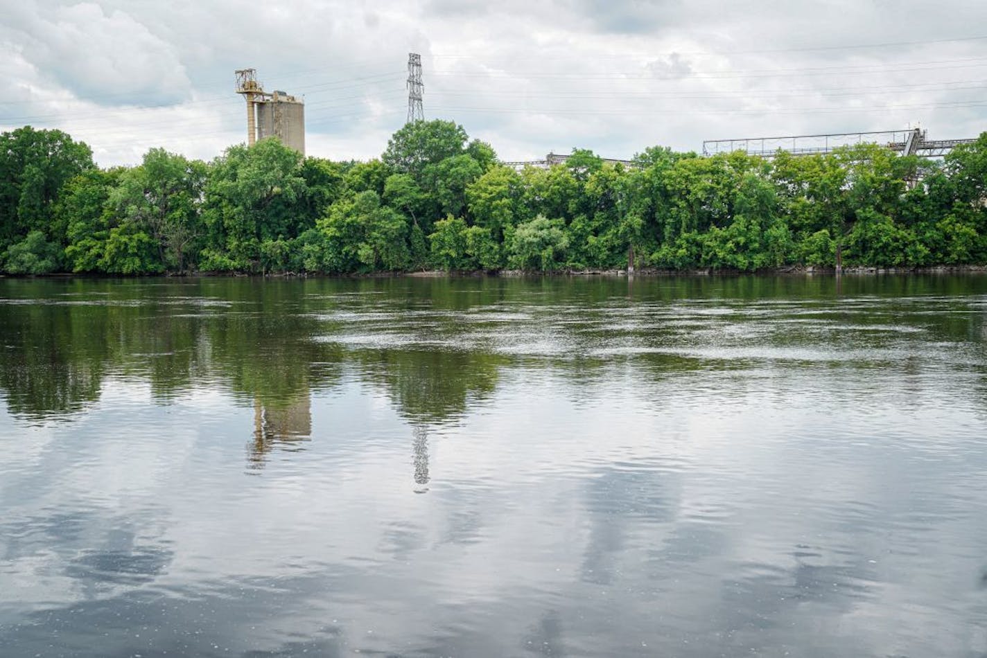 The new park is to be built at the end of N 26th Ave along the Mississippi River. This is the view from the East bank, looking west toward the location of the new park. The Continental Cement Company and Cemstone operate on both sides of the street.