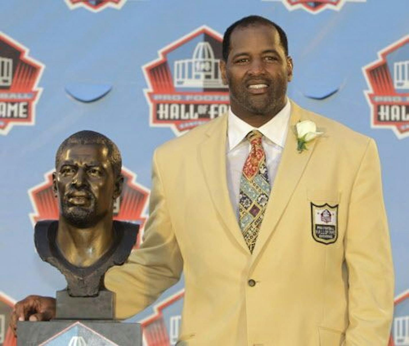 FILE - In this Aug. 6, 2011 file photo, Richard Dent poses with a bust of himself during induction ceremonies at the Pro Football Hall of Fame in Canton, Ohio.