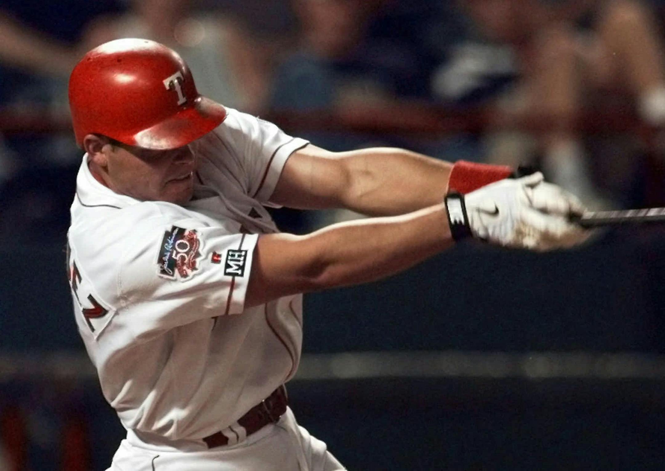 Texas Rangers Ivan Rodriguez belts a two-run homer against Minnesota Twins' pitcher Brad Radke during the third inning in Arlington, Texas, Thursday, Sept. 11, 1997. Rodriguez hit three homers during the game. Texas won 7-0. (AP Photo/Eric Gay)