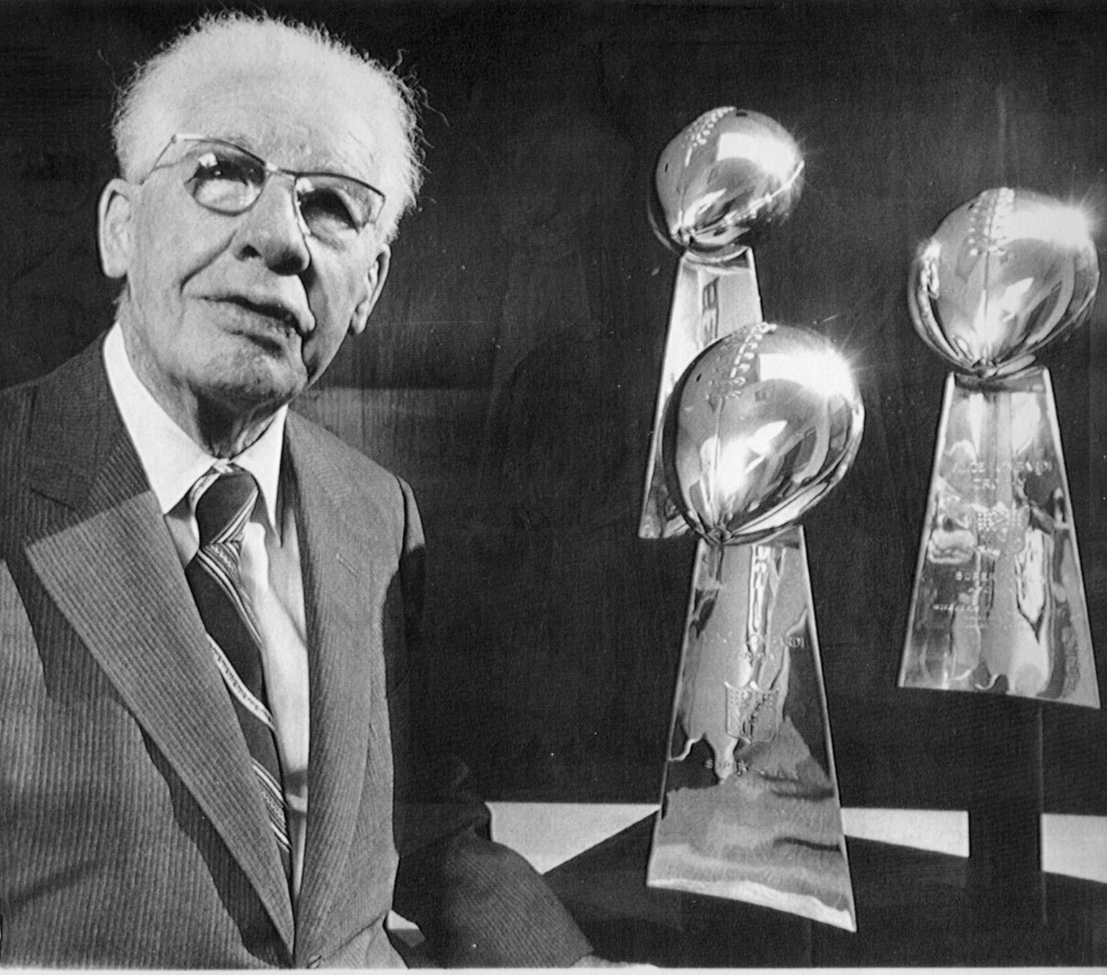 Pittsburgh Steelers pro football team founder Art Rooney Sr. posed in 1980 with three of the Steelers' four Super Bowl trophies. Associated Press file photo.