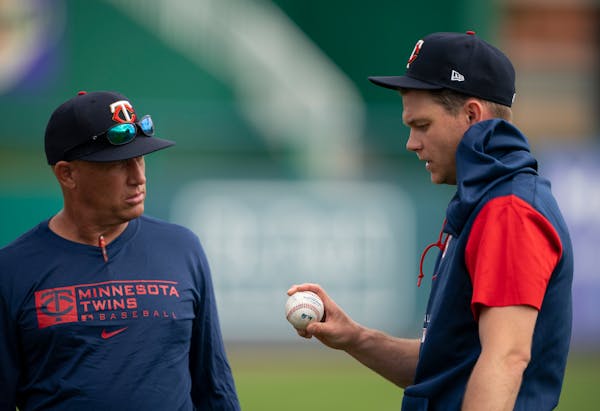 Twins pitcher Sonny Gray spoke with pitching coach Wes Johnson, left, during Tuesday’s workout.
