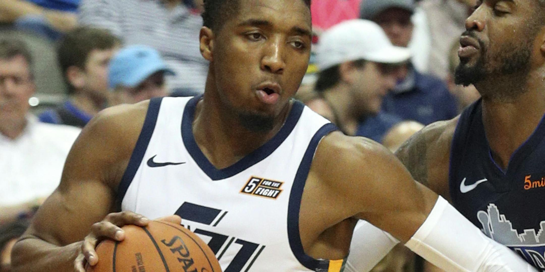 Utah Jazz guard Donovan Mitchell (45) drives the ball past Dallas Mavericks guard Wesley Matthews (23) in the second half of an NBA basketball game Sunday, Oct. 28, 2018, in Dallas. (AP Photo/Richard W. Rodriguez)