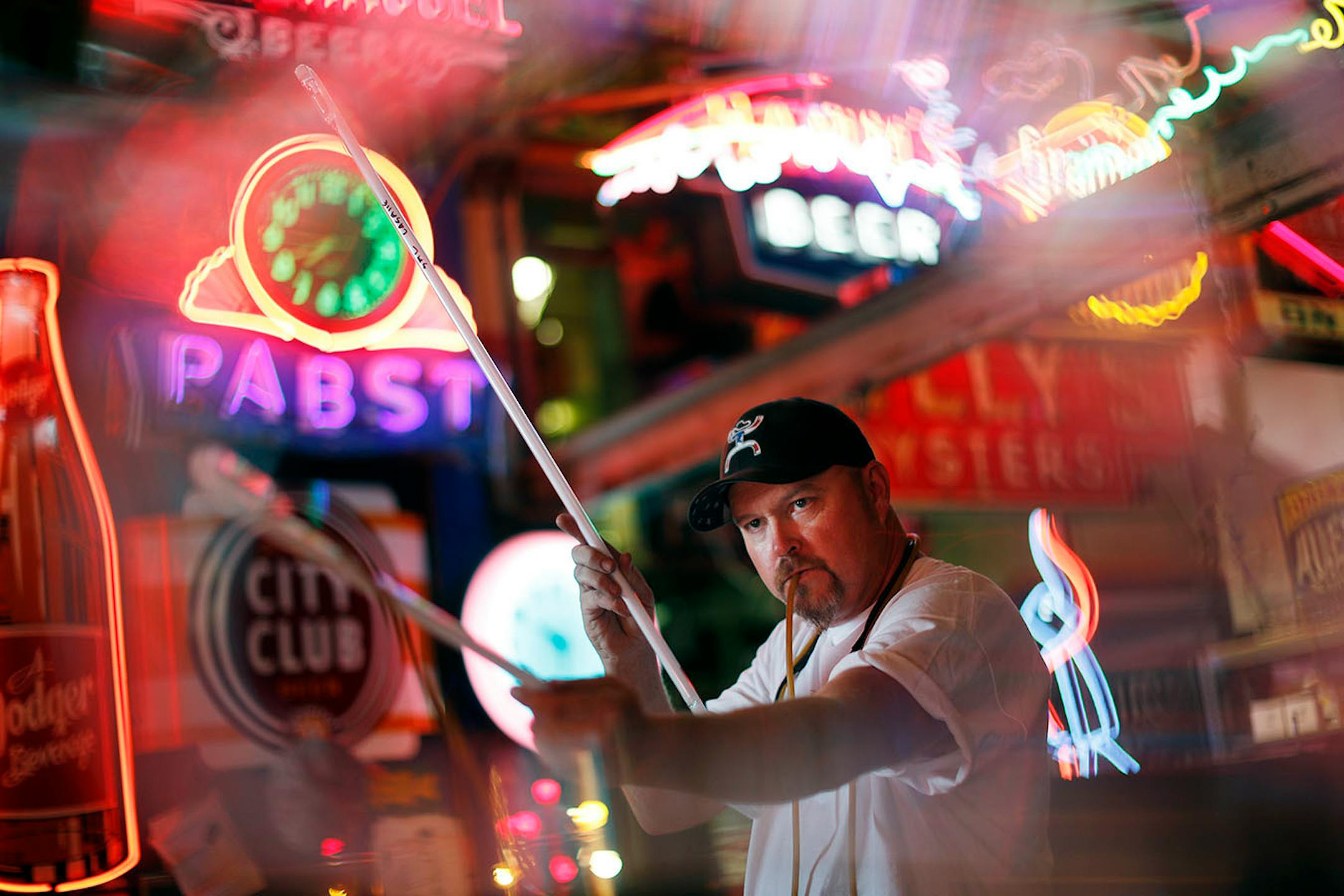 Matt Thompson, of Skyline Neon bends and shapes a glass tube using a gas flame for heat, and blowing into the tube through a tube/hose so that it retains its cylindrical shape during the process in his studio Wednesday August 17, 2016 in Minneapolis, MN.