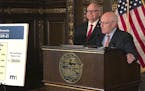 Minnesota Management and Budget Commissioner Myron Frans, right, and Gov. Tim Walz, left, brief reporters about the governor's updated budget proposal