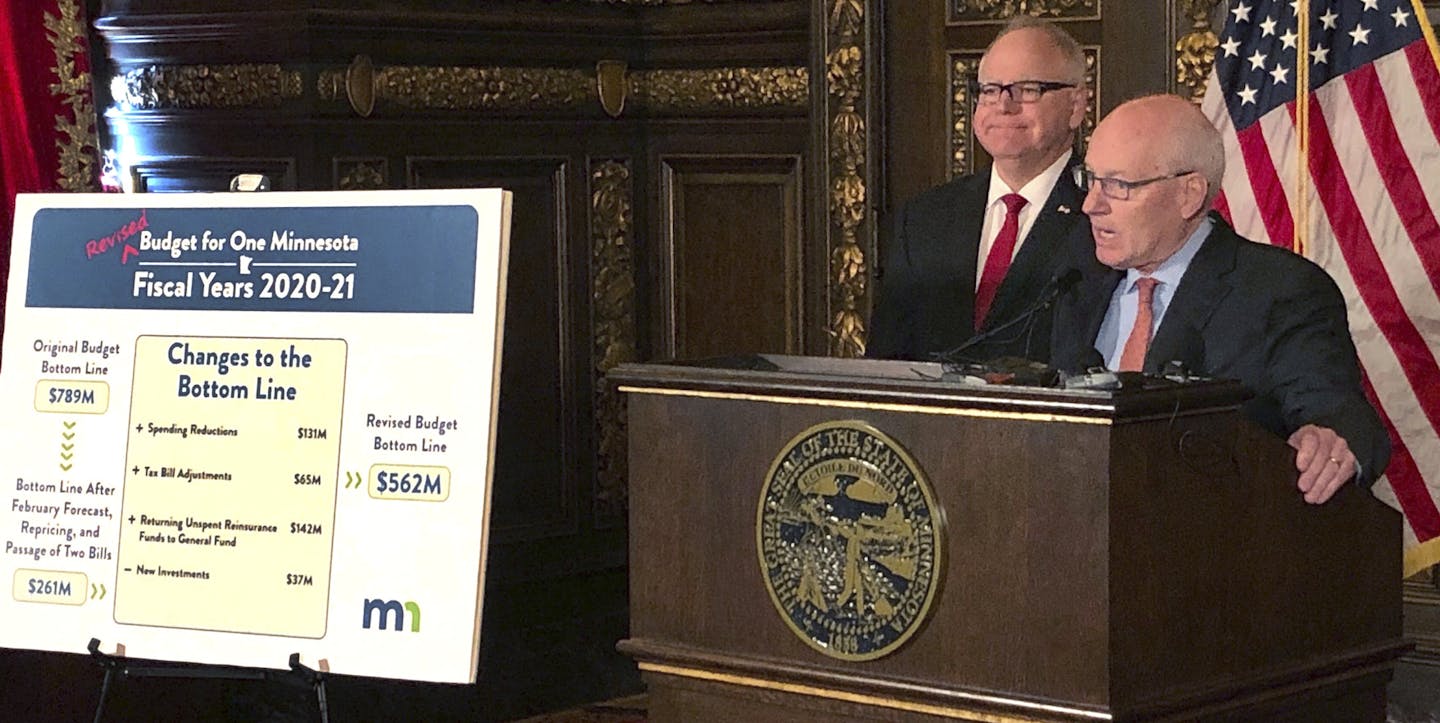 Minnesota Management and Budget Commissioner Myron Frans, right, and Gov. Tim Walz, left, brief reporters about the governor's updated budget proposal on Friday, March 22, 2019, at the state Capitol in St. Paul, Minn. Walz has announced tweaks to his budget proposal to reflect projected slower economic growth. Walz also told reporters that his administration took a hard look and scaled back some proposals while sparing priority areas like education and health care. Republican leaders criticized