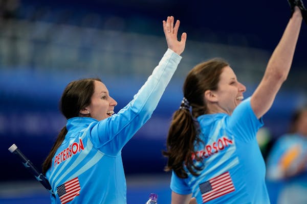 The United State's Tabitha Peterson waves to the crowd after a win against Russian Olympic Committee during a women's curling match at the Beijing Win