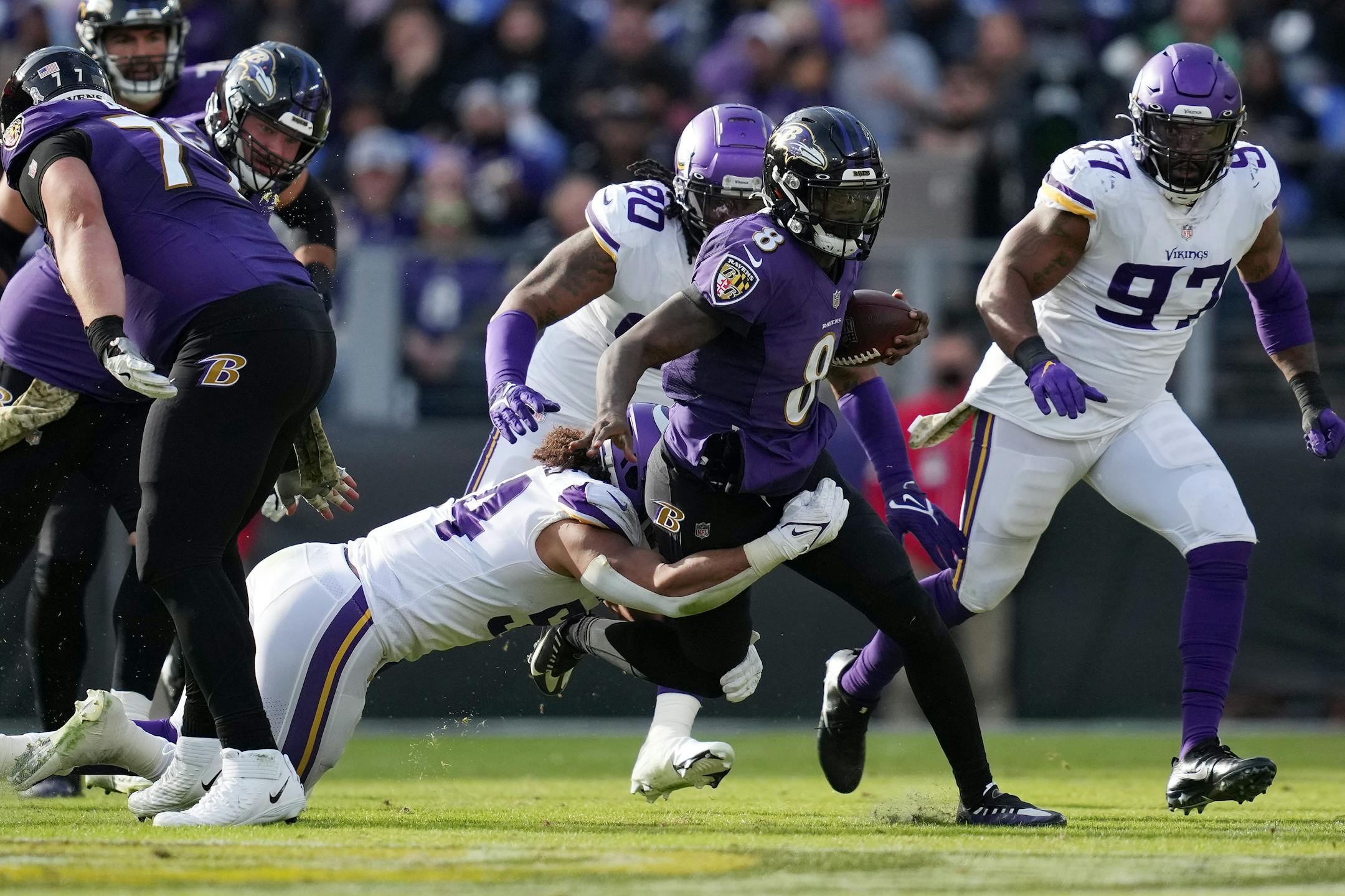 Vikings middle linebacker Eric Kendricks (54) dove on Ravens quarterback Lamar Jackson (8) as he rushed the ball in the second quarter.
