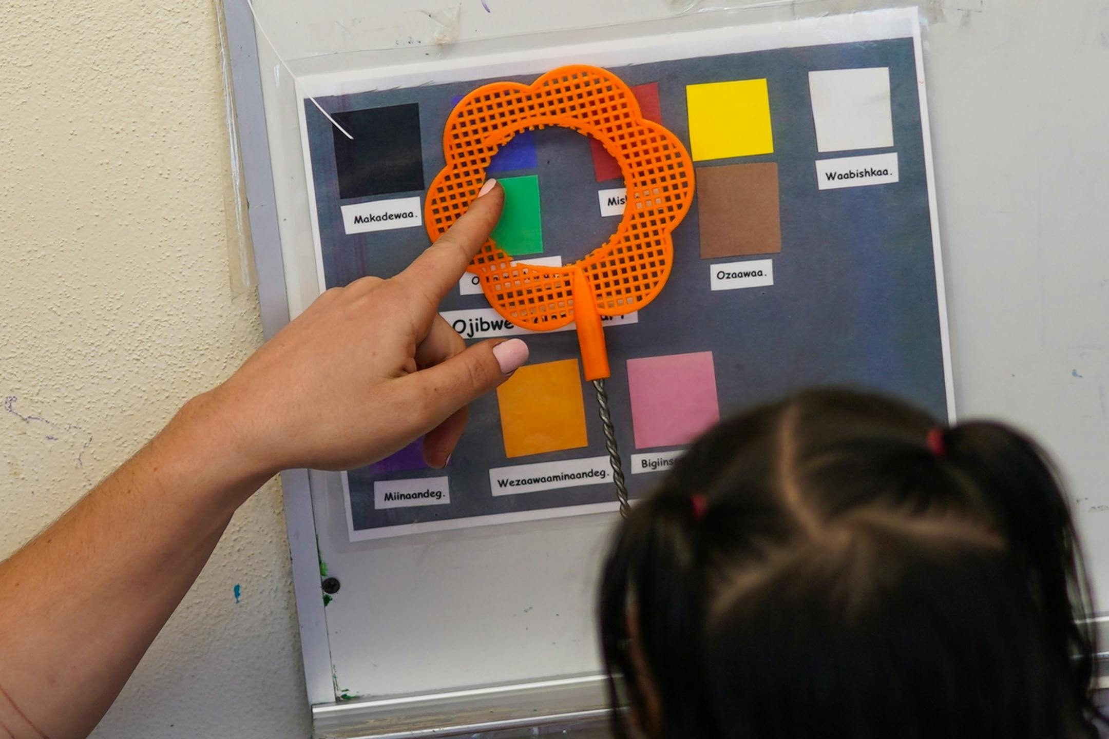 Ojibwe teacher Liz Zoongwegiizhigook Zinsli worked on colors with students in an Ojibwe immersion class for students from 18 months to 5 years old, at Four Directions school.
