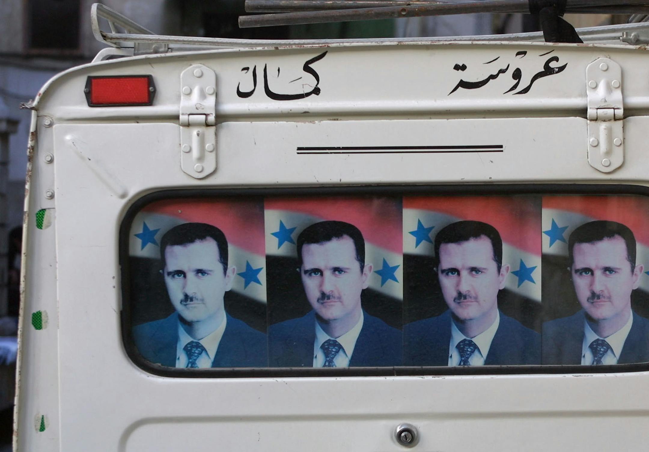 DAMASCUS -11/10/01 - Faces and Voices of the Islamic World. IN THIS PHOTO: President Bashar al-Assad's likeness is ubiquitous in Syria, as is that of his late father, Hafez al-Assad. The son's face was posted in a vehicle window. ORG XMIT: MIN2015091815572880