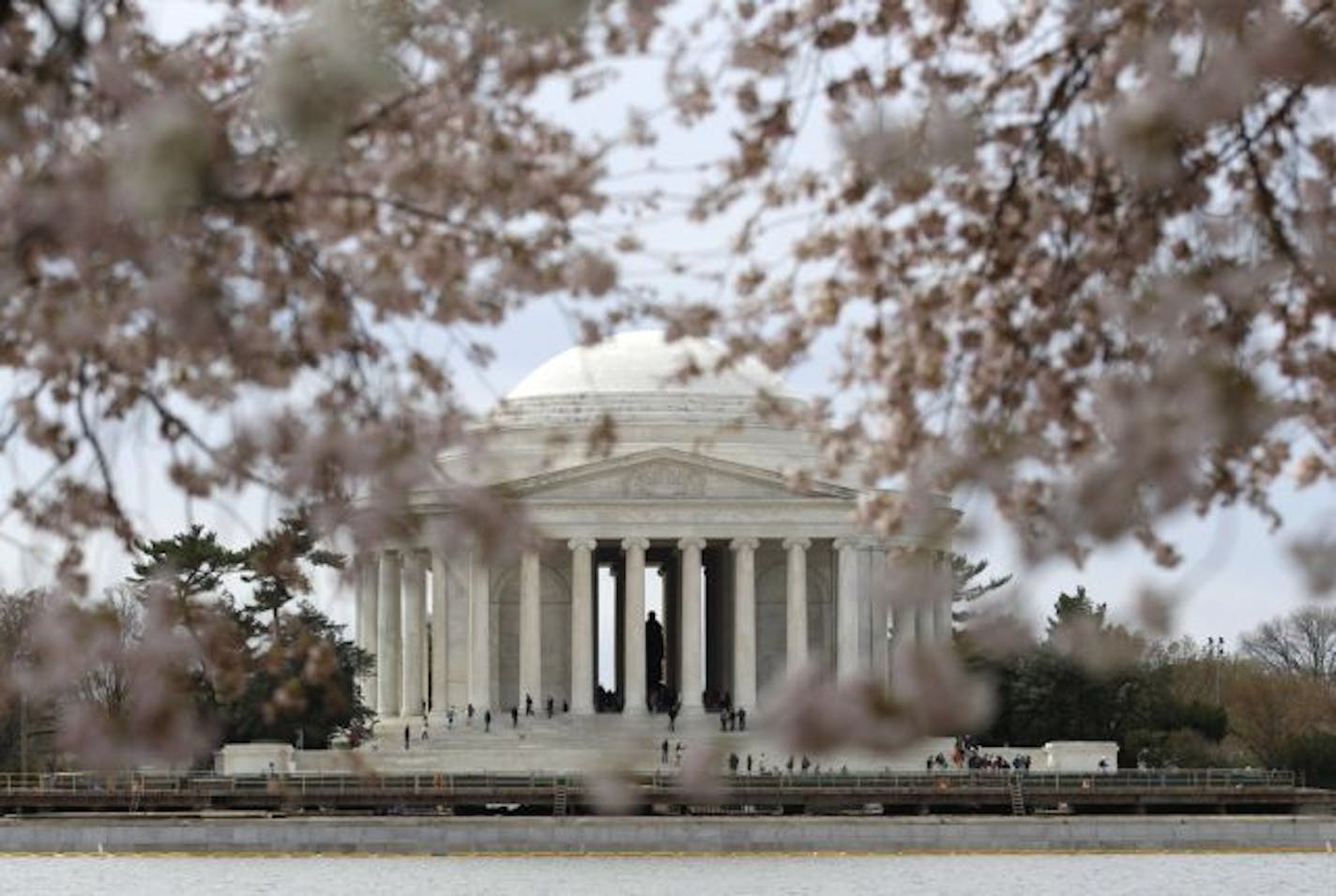 The Jefferson Memorial is seen through blossoming cherry trees across the Tidal Basin in Washington, Monday, March 28, 2011. The National Cherry Blossom Festival runs through April 10.