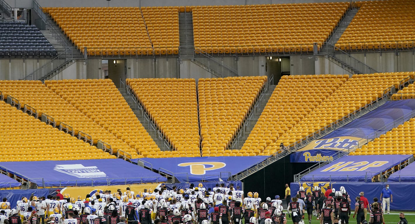 The Pittsburgh football team looks toward the empty bleachers after defeating Austin Peay in an NCAA college football game, Saturday, Sept. 12, 2020, in Pittsburgh. In a quirk this season, No. 5 Notre Dame enjoys a greater home-field advantage than most of its opponents: As of now, the Fighting Irish are slated to play in front of only one crowd bigger than their own, which is limited to about 10,000 people because of the pandemic. Pitt, Boston College, North Carolina and Wake Forest have not al