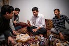 Khyber Malikzai, left, his newly immigrated brother Fahim, Sher Mulakhail and his newly arrived close friend Mirwais Momand enjoy tea and talking to e